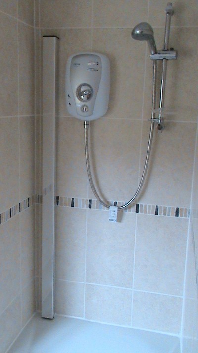 bathroom tile design with Outasight and electric shower