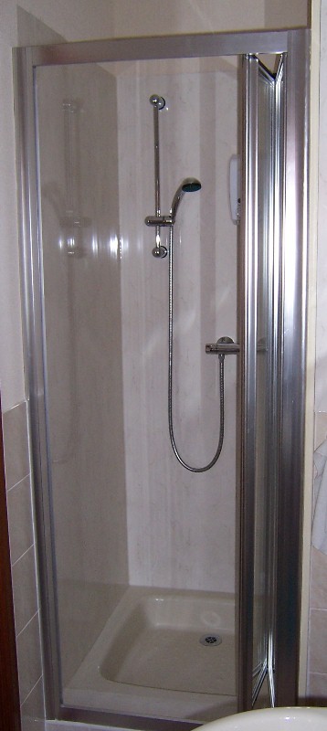 bi-fold shower door on a recessed cubicle