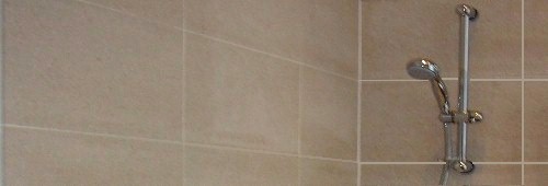 limstone tiles in a shower area